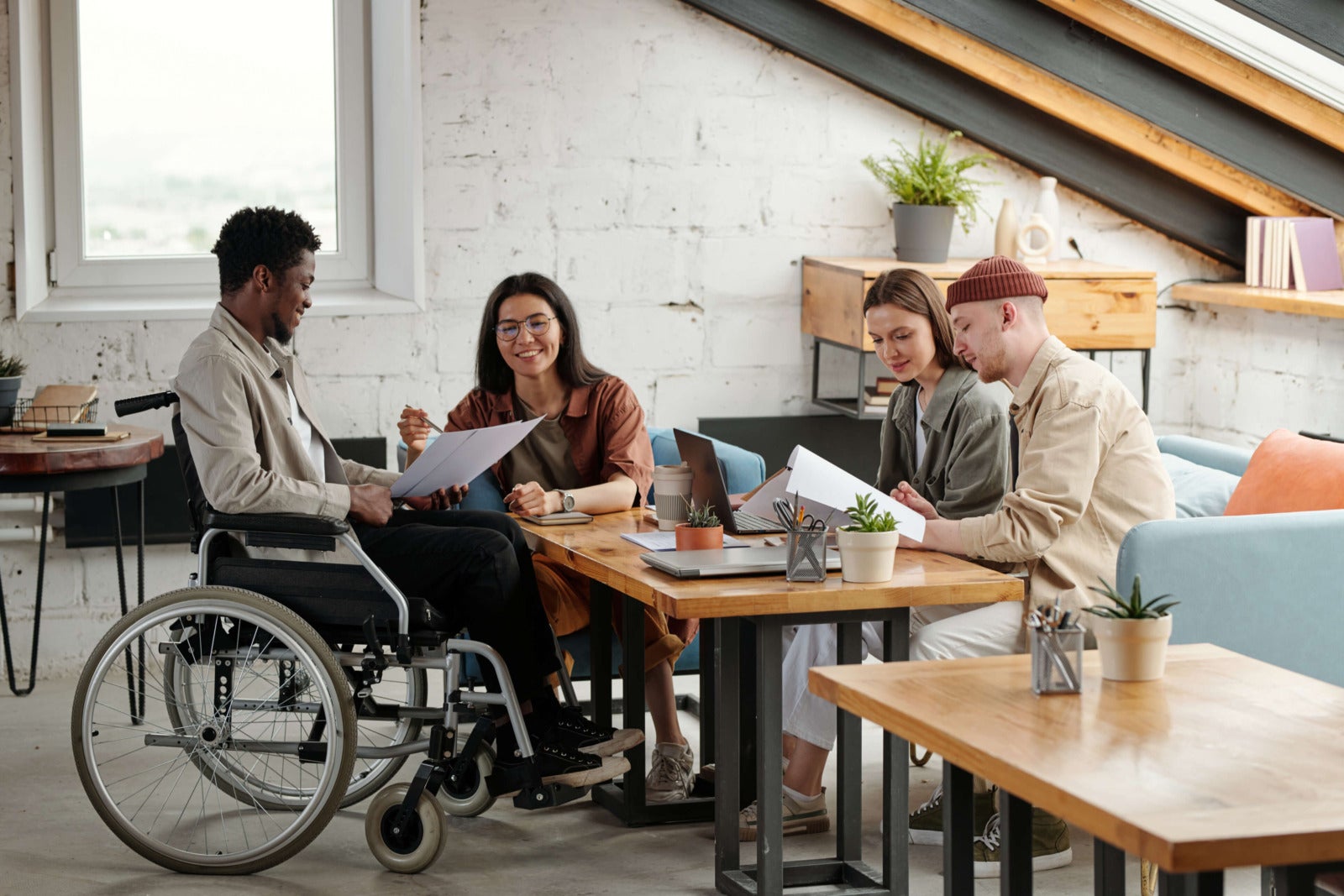 diverse colleagues look over business papers at office work station